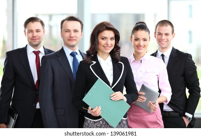 Group Portrait Of A Professional Business Team Looking Confidently At Camera