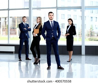 Group Portrait Of A Professional Business Team Looking Confidently At Camera