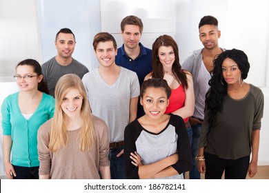 Group Portrait Of Smiling Multiethnic College Students Standing Together In Classroom