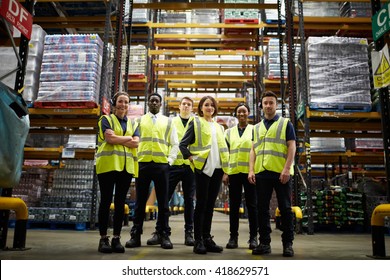 Group Portrait Of Staff At Distribution Warehouse, Low Angle