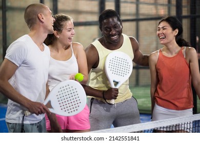 Group portrait of team of padel players standing at tennis court at fitness health club - Powered by Shutterstock