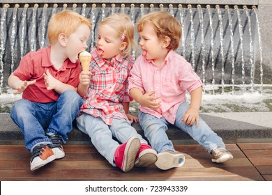 Group Portrait Of Three White Caucasian Cute Adorable Funny Children Toddlers Sitting Together Sharing Ice-cream Food. Love Friendship Jealousy Concept. Best Friends Forever. 