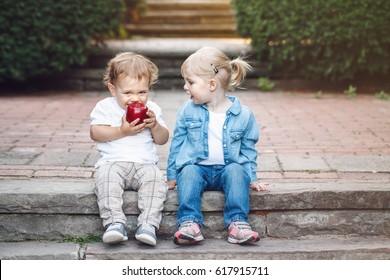 Group Portrait Of Two White Caucasian Cute Adorable Funny Children Toddlers Sitting Together Sharing Eating Apple Food, Love Friendship Childhood Concept, Best Friends Forever