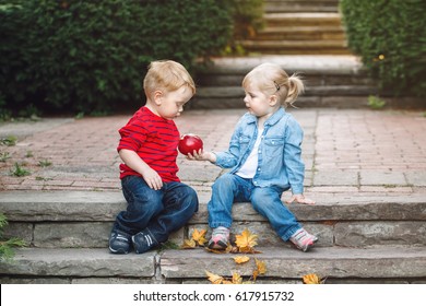 Group Portrait Of Two White Caucasian Cute Adorable Funny Children Toddlers Sitting Together Sharing Apple Food Love Friendship Childhood Concept Best Friends Forever