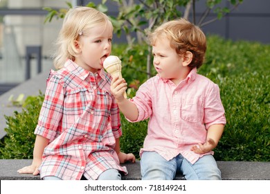 Group Portrait Of Two White Caucasian Cute Adorable Funny Children Toddlers Sitting Together Sharing Ice-cream Food. Love Friendship Concept. Best Friends Forever. 