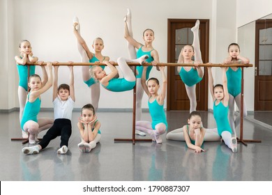 Group portrait of young ballerinas near the ballet barre