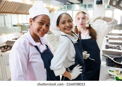 Group portrait young wman cooking student. Cooking class. culinary classroom. group of happy young woman multi - ethnic students are focusing on cooking lessons in a cooking school.  - Shutterstock ID 2166938013