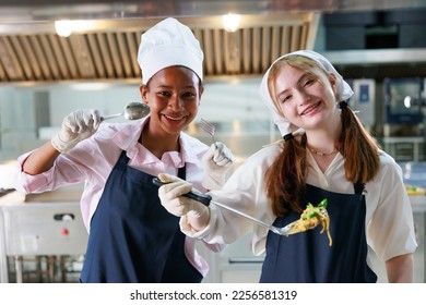 Group portrait young wman cooking student. Cooking class. culinary classroom. group of happy young woman multi - ethnic students are focusing on cooking lessons in a cooking school.  - Powered by Shutterstock