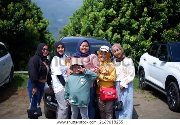 the group pose in front off the car. June 19th,\
2022, yogyakarta, Indonesia