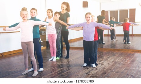 Group Of Positive Children Learning Tango In Dance Studio