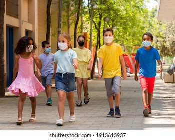 Group of positive children in masks walking together on the street - Powered by Shutterstock