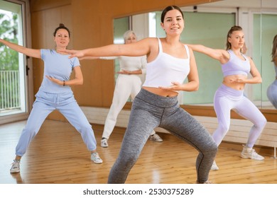 Group are practising arch movement in step jazz dance in fitness-gym