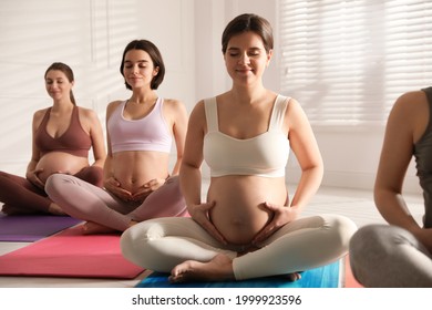 Group Of Pregnant Women Practicing Yoga In Gym