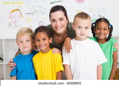 Group Of Preschool Kids And Teacher In Classroom