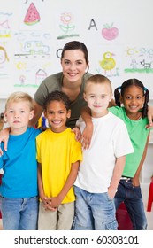 Group Of Preschool Kids And Teacher In Classroom