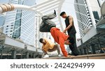 Group of professional happy street dancer cheer up while asian hipster perform b boy dance at urban city surrounded by people with low angle camera. Break dance concept. Outdoor sport 2024. Sprightly.