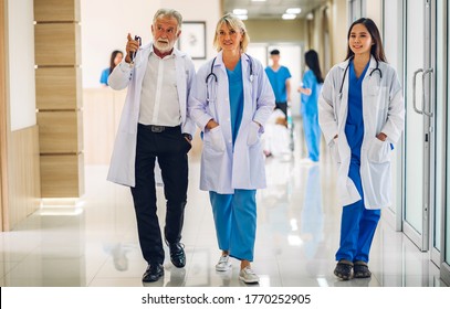 Group Of Professional Medical Doctor Team With Stethoscope In Uniform Working Discussing And Talk Walking In Hospital.health Medical Care Concept