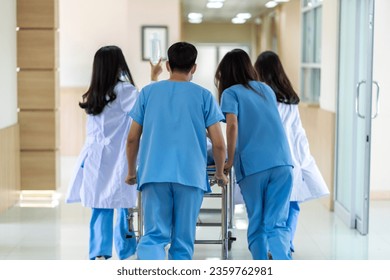 Group of professional medical doctor team and assistant with stethoscope in uniform taking seriously injured coma patient to operation emergency theatre room in hospital.health medical care concept - Powered by Shutterstock