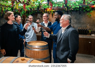 Group of Professional sommelier tasting and smelling red wine in wine glass at wine cellar with wooden barrel in wine factory. Winery liquor manufacturing industry and winemaker business concept. - Powered by Shutterstock