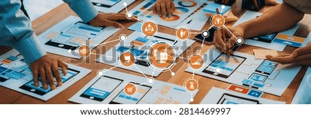A group of professionals collaborates in a modern workspace, interacting with various digital interfaces and visual data, showcasing teamwork and creativity in planning. Amity
