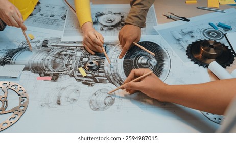 A group of professionals collaborates on a detailed engineering blueprint in a modern workspace, using pencils to highlight critical design elements and showcase teamwork. SACTR