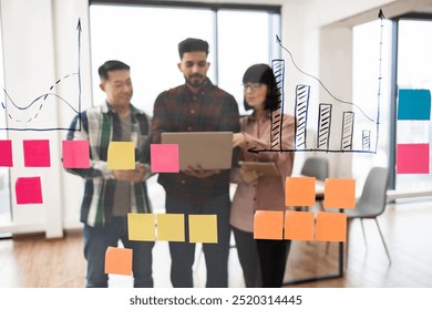 Group of professionals collaborating in business meeting with focus on data analysis and brainstorming session. Team discussing charts on transparent board with colorful sticky notes. - Powered by Shutterstock