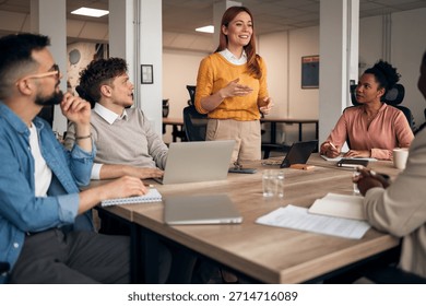 A group of professionals engaged in a collaborative discussion during a business meeting, promoting teamwork, innovation, and productivity in a contemporary office environment.