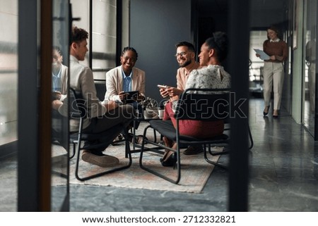 A group of professionals engaging in a collaborative discussion in a modern workspace. The team members are cheerful, emphasizing teamwork and collaboration in the office environment.