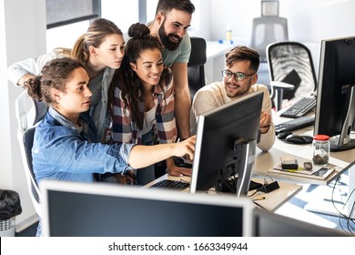 Group Of Programmers Discussing About New Project.They Looking At The Computer Screen And Testing The Code.Developing New Software.	
