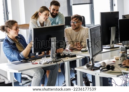 Group of programmers and game developers working on a new project at the office.	

