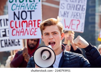 Group Of Protestors With Placards And Megaphone On Demonstration March Against Climate Chane - Shutterstock ID 2140793951