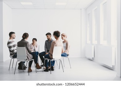 Group psychotherapy in white interior - Powered by Shutterstock