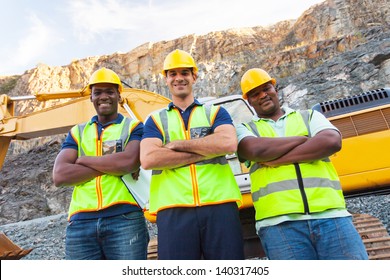 Group Of Quarry Workers Standing Next To Excavator With Arms Crossed