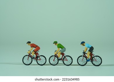 A group of racing cyclists isolated on light background, view from the side - Shutterstock ID 2231634985