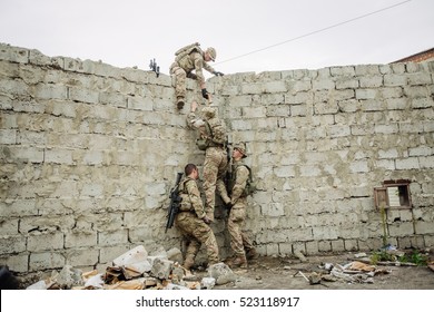 Group of rangers team climbing from a wall