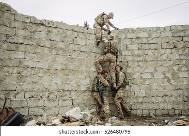 Group Of Rangers Team Climbing From A Wall