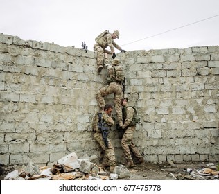 Group Of Rangers Team Climbing From A Wall