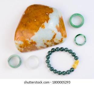 Group Of Raw Jade And Jewelry On White Background