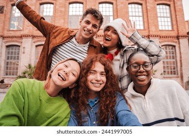 Group of real teenage students having fun jumping up at university campus. Young adult multiracial friends leaping at high school. Happy excited teens celebrating after pass the exams. Academic goal - Powered by Shutterstock