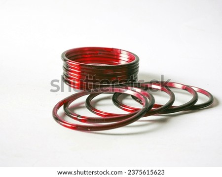 A Group of red color ladies traditional glass bangles isolated on white background