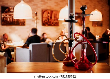 group of red hookahs shisha on table in interior