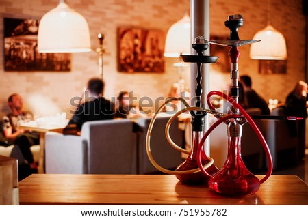 group of red hookahs shisha on table in interior