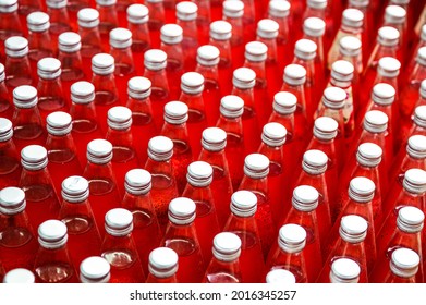 Group of red juice bottles with screw cap in conveyor belt at beverage processing plant - Powered by Shutterstock