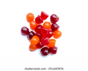 Group of red, orange and purple multivitamin gummies isolated on white background. Healthy lifestyle concept.