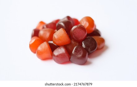 Group Of Red, Orange And Purple Multivitamin Gummies Isolated On White Background