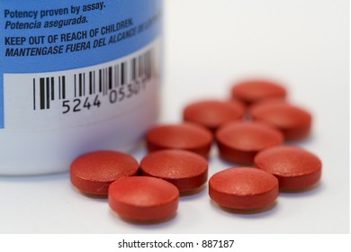 Group Of Red Pills With Visible Warning Label From Bottle And Altered Barcode