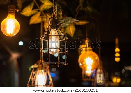 Group of retro style ceiling lighting lamp with warming light glowing bulb. Interior decor, selective focus object. Photo contained some noise and high constrast ratio due to low light condition.