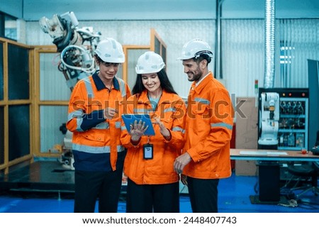 A group of Robotics engineers working with Programming and Manipulating Robot Hand, Industrial Robotics Design, High Tech Facility, Modern Machine Learning. Mass Production Automatics.