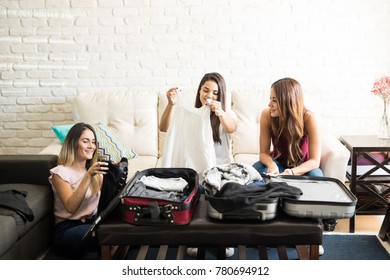 Group Of Roomates Packing Their Bags Together And Going On Vacation