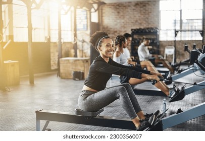 Group, rowing machine and training in gym, class or fitness workout, exercise or cardio, row team and practice. People, healthy athlete and challenge on sport equipment, row crew and sports club - Shutterstock ID 2300356007